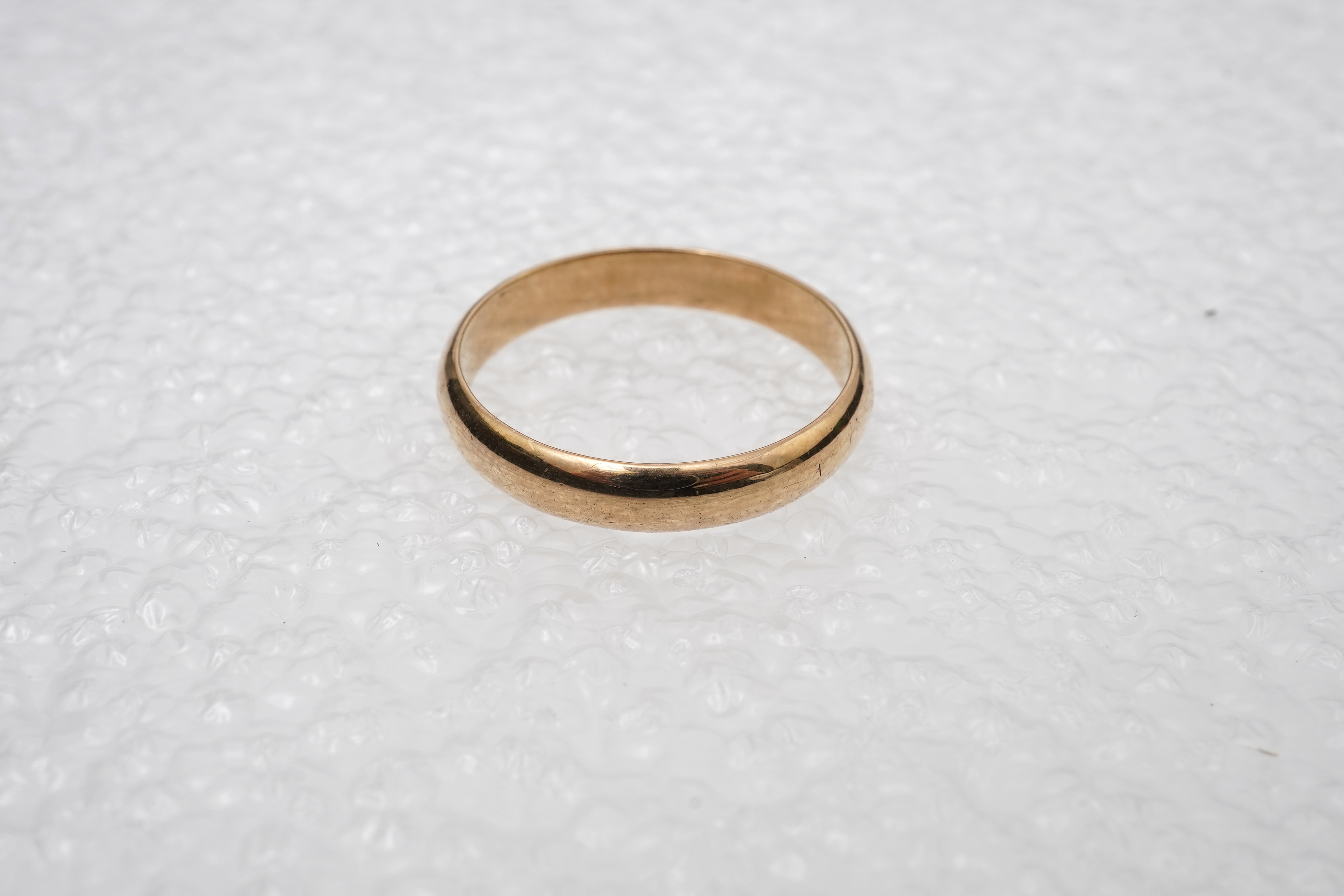 A yellow metal wedding band, a pair of 9ct gold plain oval cufflinks and a 9ct bar brooch, gross weight 11 grams.